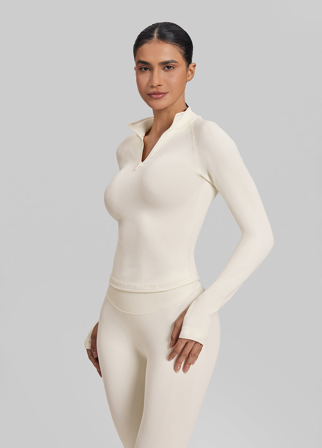 Haut en tricot sergé sans couture à coupe ajustée avec fermeture éclair mi-longue et trous pour les pouces