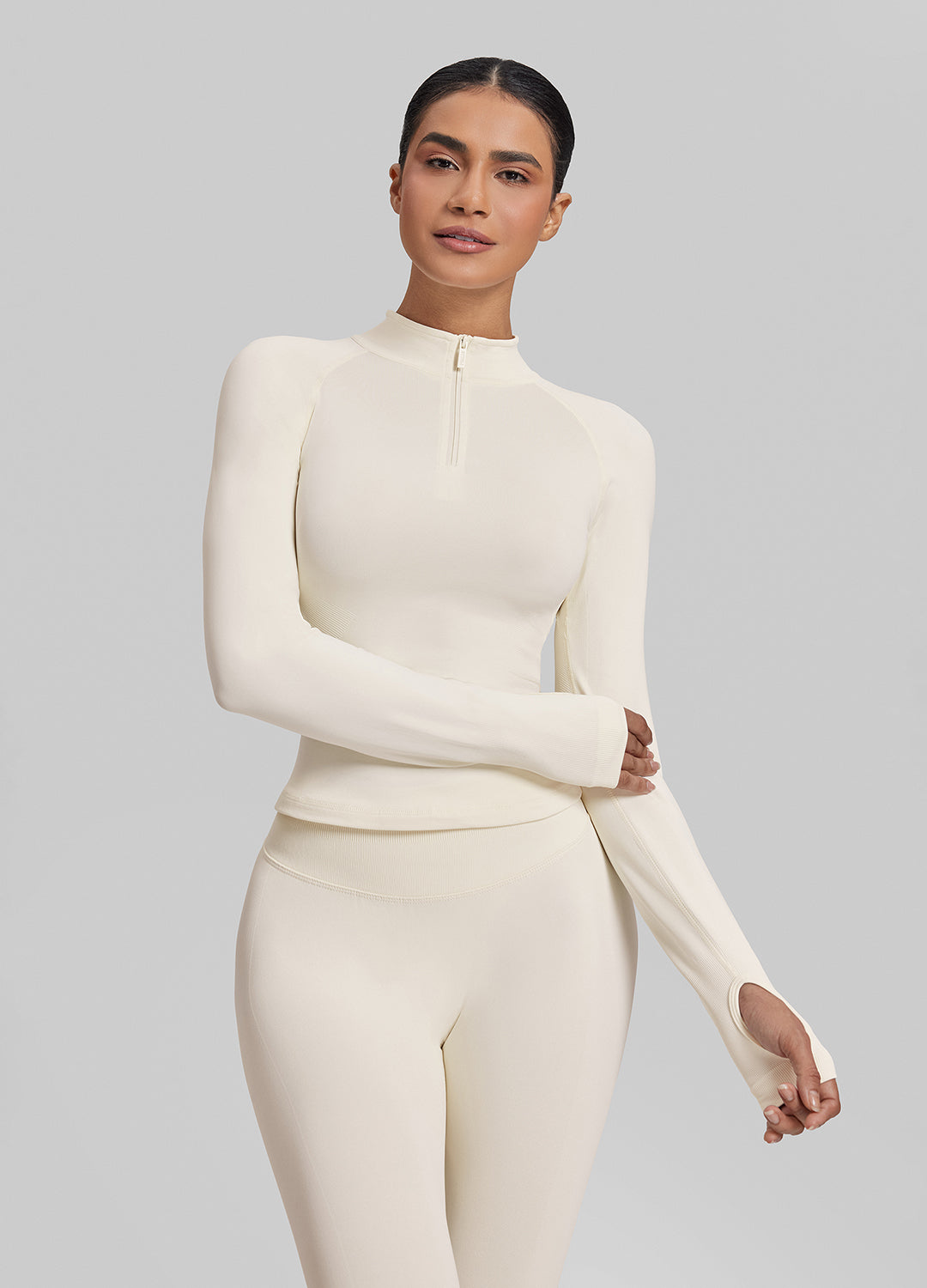 Haut en tricot sergé sans couture à coupe ajustée avec fermeture éclair mi-longue et trous pour les pouces