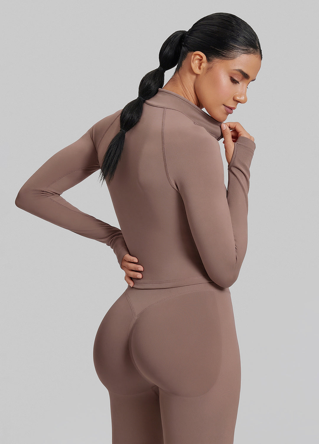 Haut mi-zippé en tricot sergé sans coutures, près du corps, coupe longue, avec passe-pouces